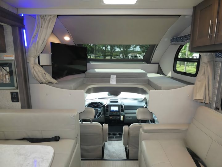 Cab-over bunk and swivel TV