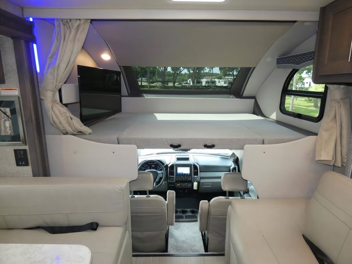 Cab-over bunk and swivel TV