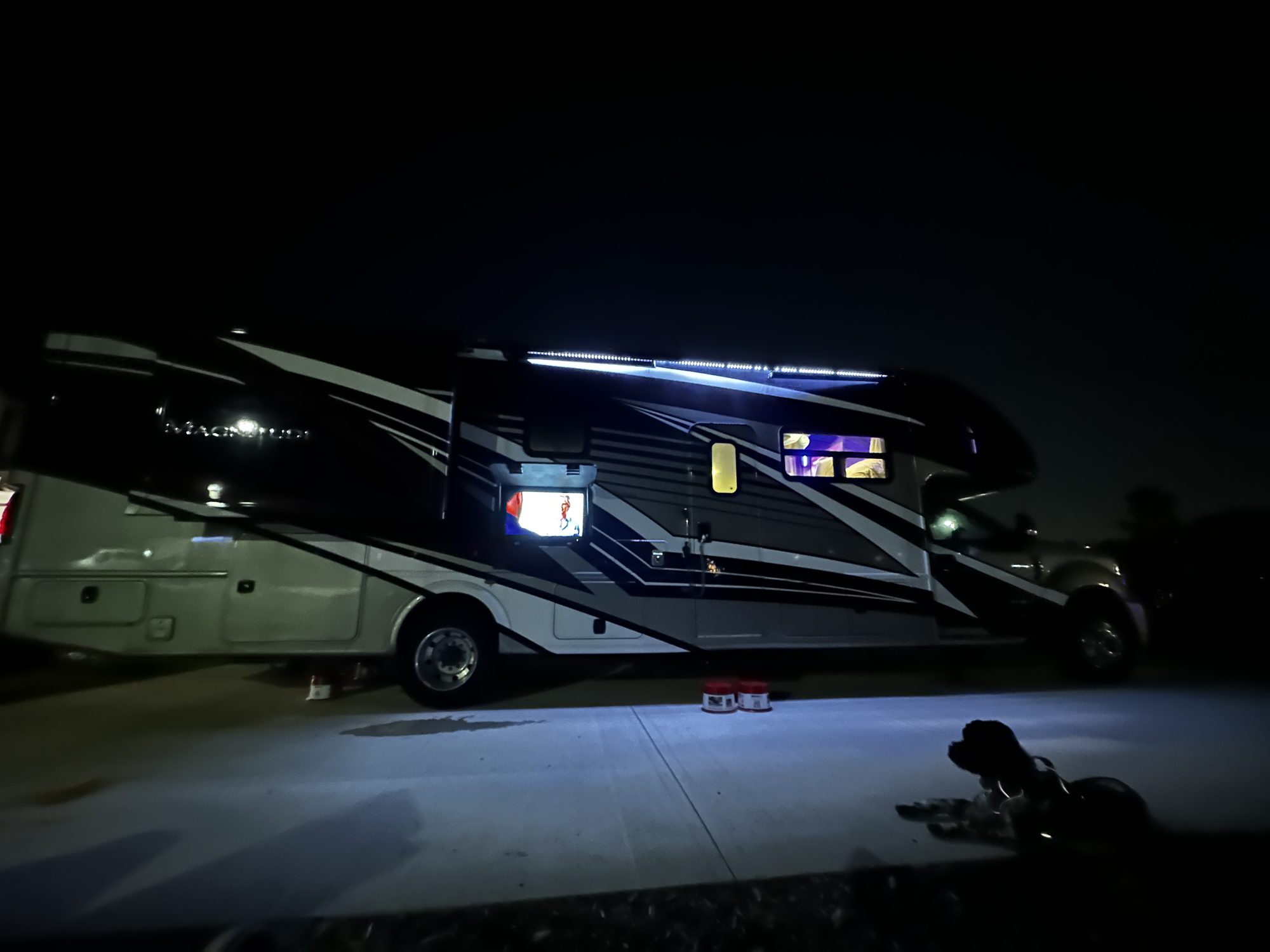 The motorhome at night with its exterior lights on